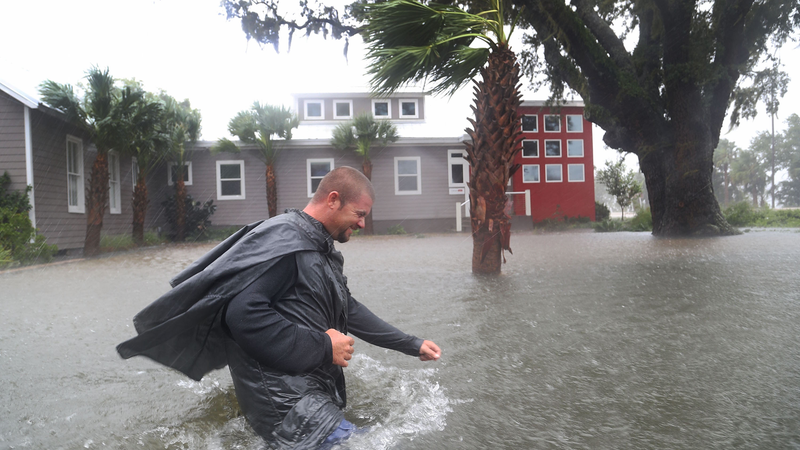 Nick Lomasney walks through heavy wind and a flooded street as Hurricane Matthew passes through the area on October 7, 2016 in St Augustine, Florida. Florida, Georgia, South Carolina and North Carolina all declared a state of emergency in preparation of Hurricane Matthew. (Image: Getty)